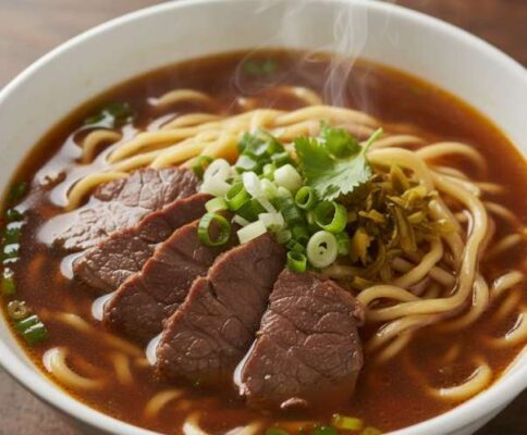 Một tô mì bò Yong Kang bốc khói nghi ngút với những miếng thịt bò hầm mềm, sợi mì vàng và hành lá xanh